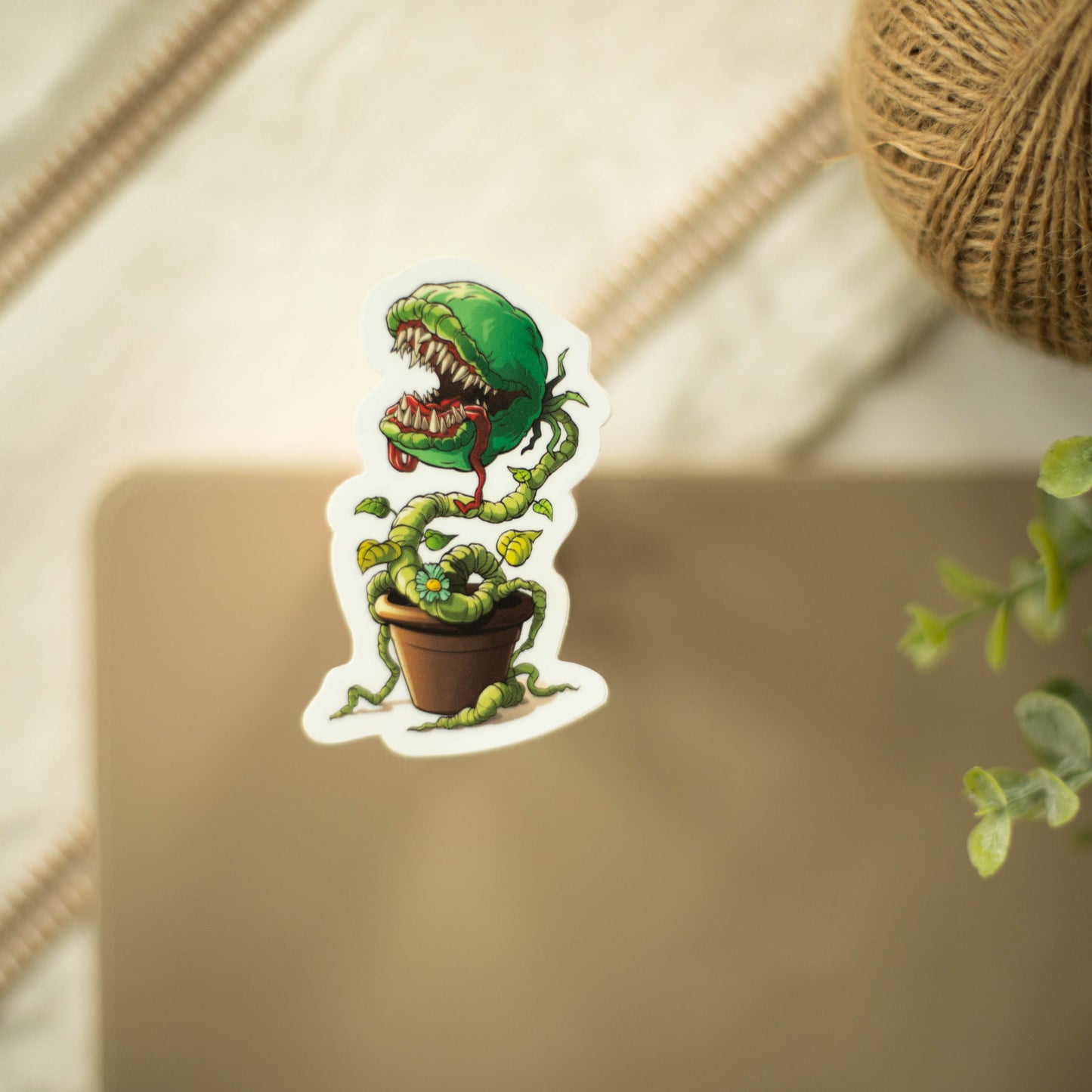 A vinyl sticker of a venus flytrap in a pot on a fancy background