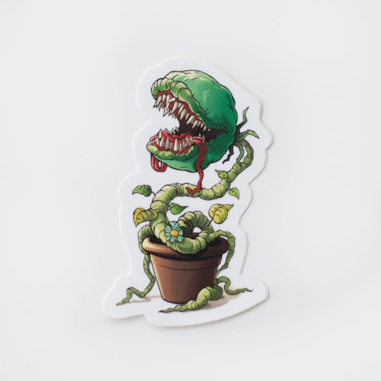 A vinyl sticker of a venus flytrap in a pot on a white background